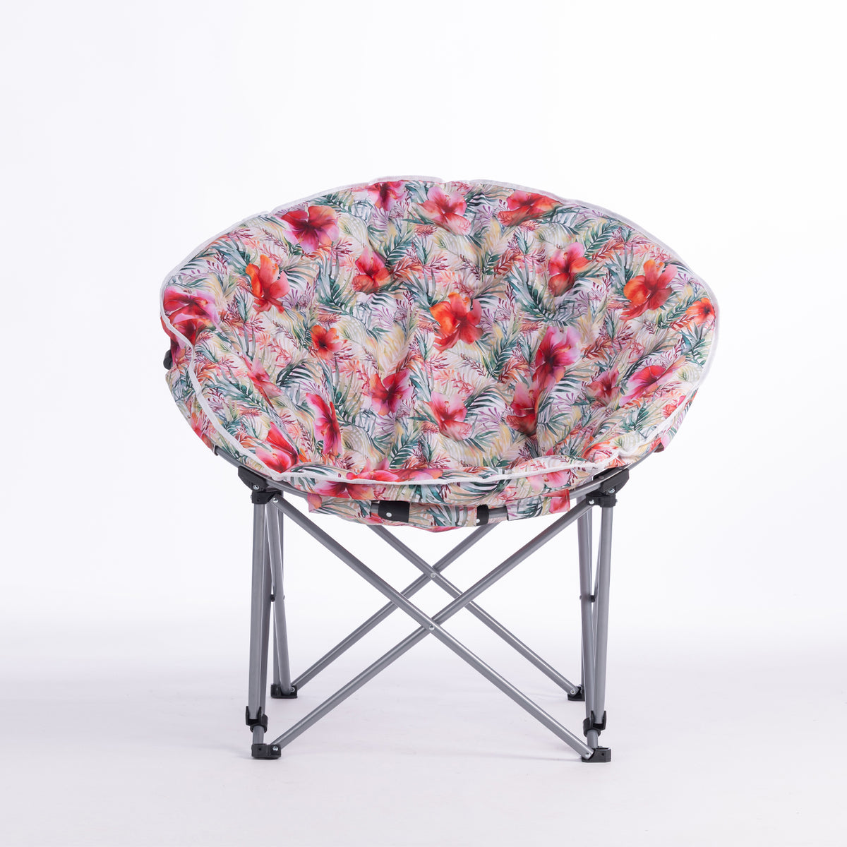 A folding moon chair with a curved, crescent-shaped seat upholstered in a vibrant tropical floral print, supported by a silver metal frame, shown on a white studio background.