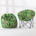 A green tropical leaf print bean bag chair and a matching green tropical leaf print folding moon chair with a gray metal frame, displayed on a clean white studio floor.