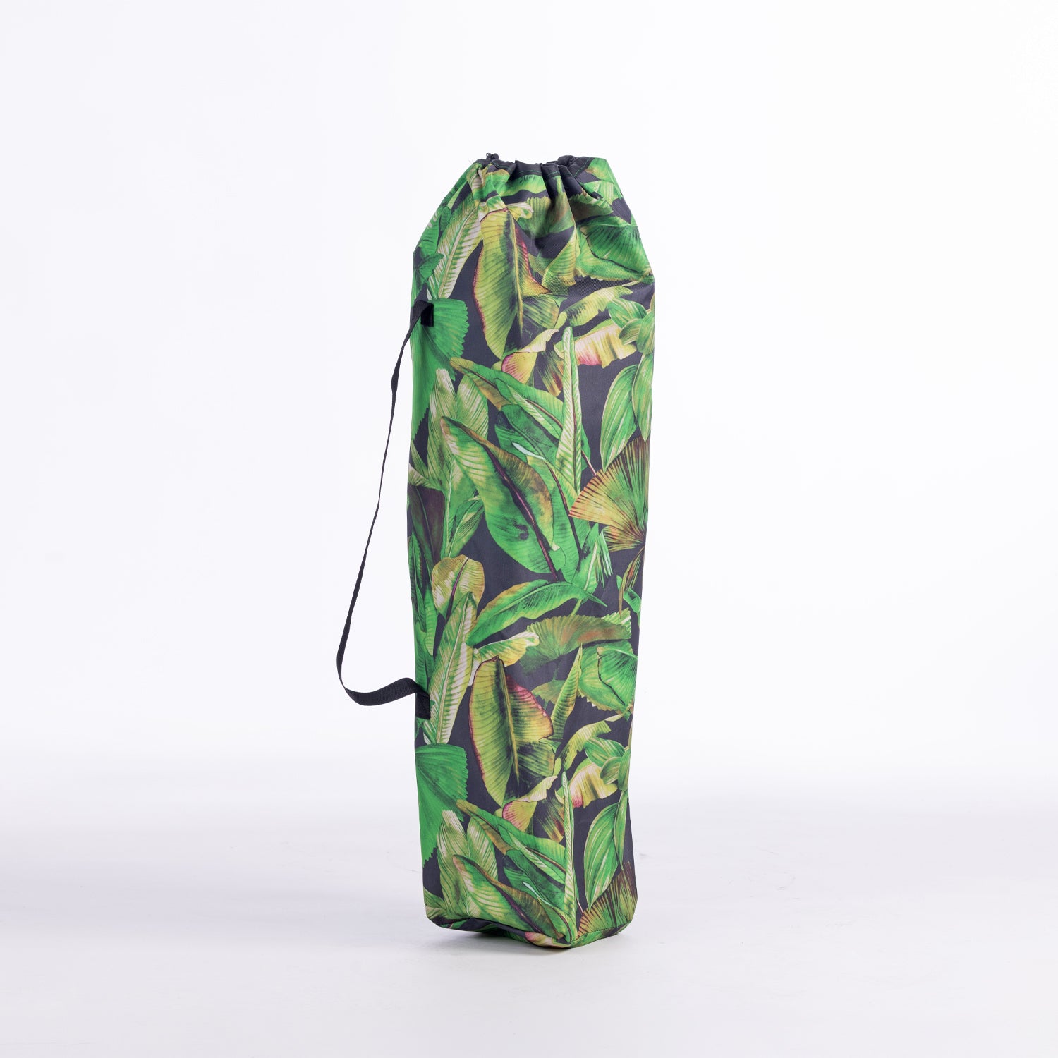 A drawstring moon chair bag with a green tropical banana leaf pattern, standing upright on a white studio background.
