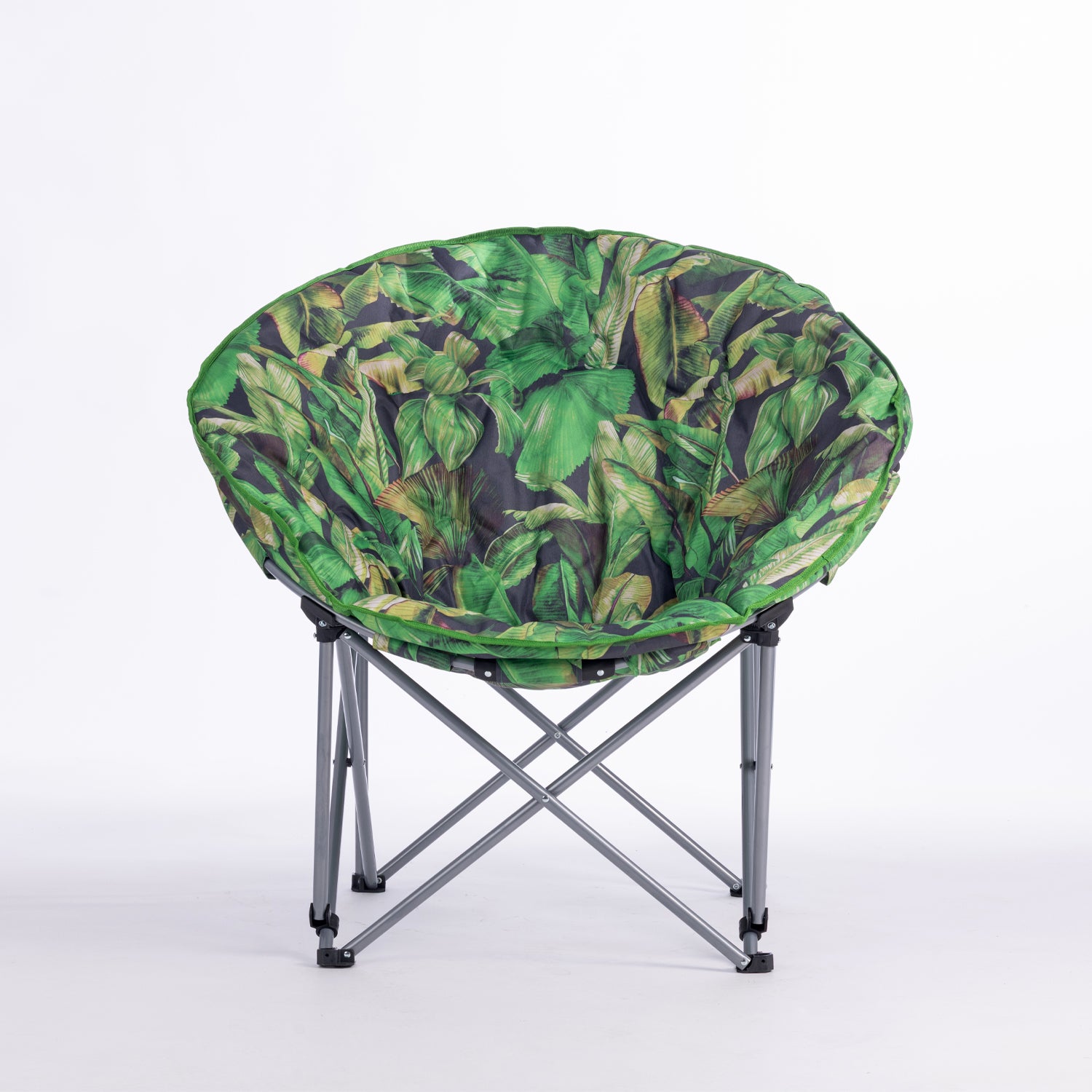 A round folding moon chair with a green tropical leaf print fabric cushion on a silver metal frame, photographed against a seamless white studio background.