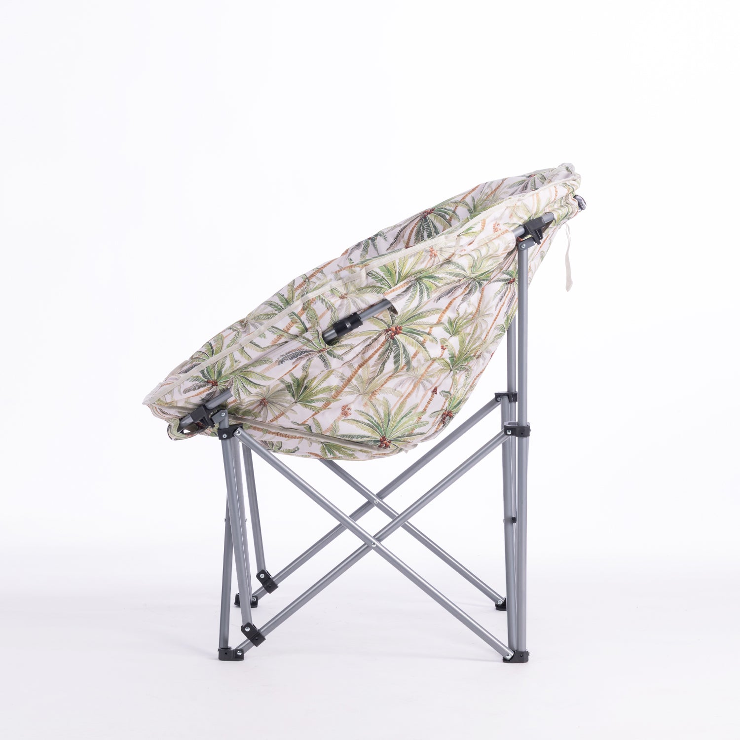 A folding moon chair with a ivory-colored fabric seat cushion featuring a green palm tree pattern, supported by a silver metal frame, shown against a plain white background.