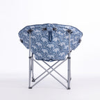 A folding moon chair with a blue and white palm tree patterned fabric seat cushion and a silver metal frame, shown on a plain white background.