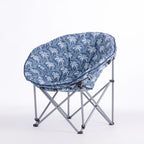 A folding moon chair with a blue and white palm tree patterned fabric seat cushion and a silver metal frame, shown on a plain white background.