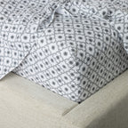 Close-up of patterned fabric on a beige surface