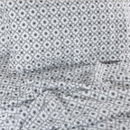 Floral patterned fabric with a lattice design on a white background