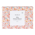 Marlo Mia Floral fitted sheet folded in packaging featuring the all-over floral design in soft pink, coral, yellow and blue tones.