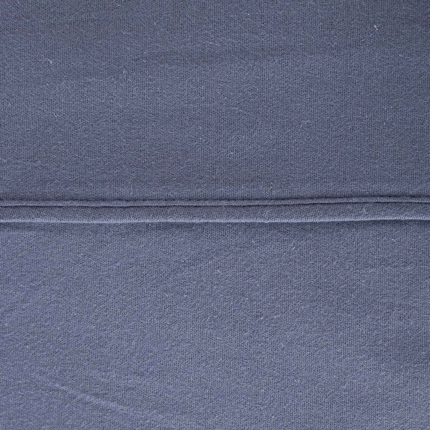 Close-up of dark blue fabric with a visible seam