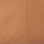 Close-up of brown fabric with a seam running vertically.
