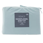 Folded light blue microflannel sheet set with a label on a white background