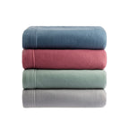 Stack of four folded towels in blue, red, green, and gray on a white background