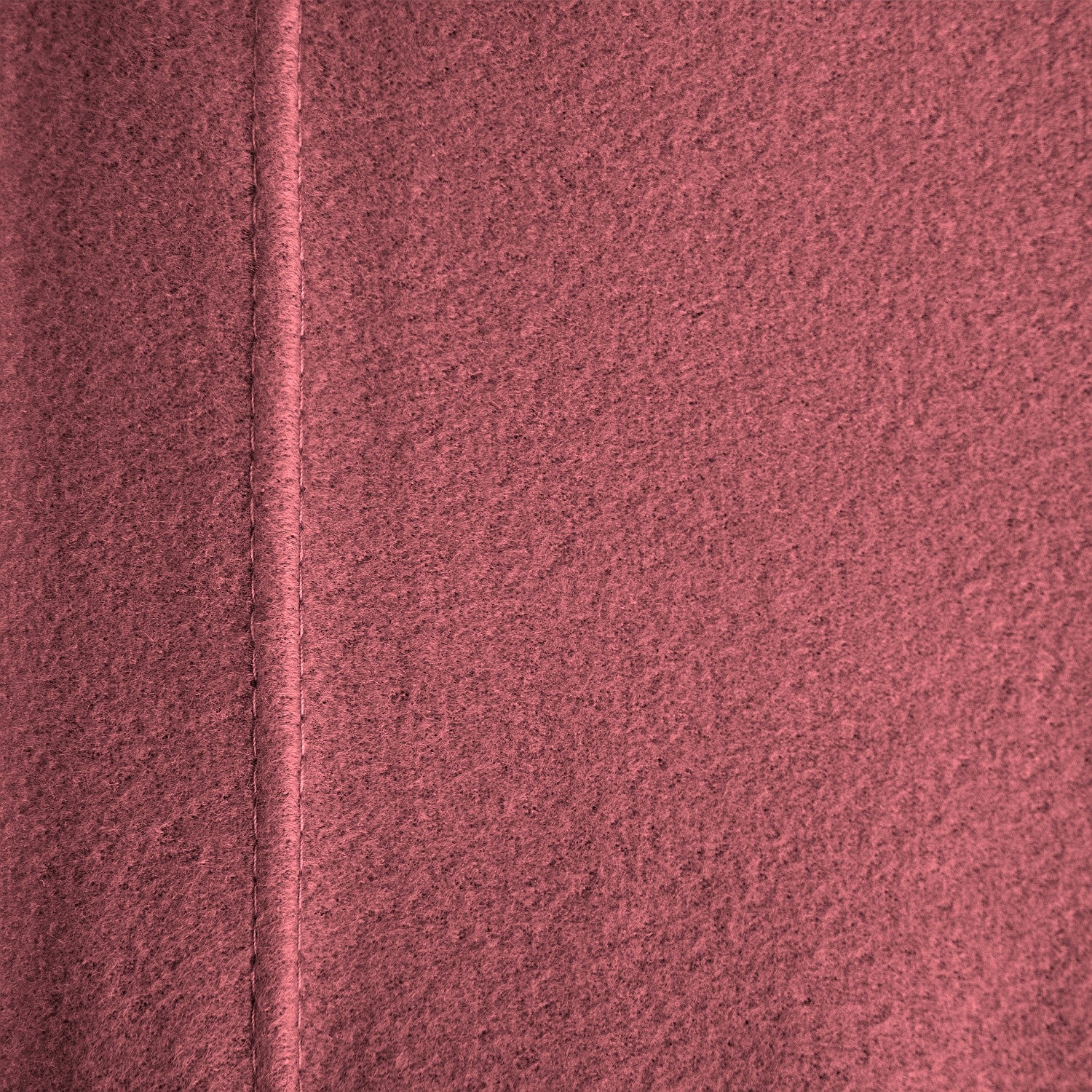 Close-up of a textured pink surface with a diagonal line.