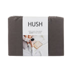 Folded gray fitted sheet with 'Hush' branding on a white background