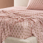 Close-up of the Marlo Mia fitted sheet showcasing the soft pink floral motif print and smooth cotton sateen finish.