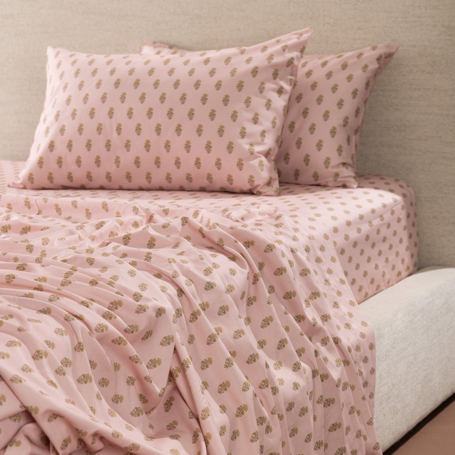 Marlo Mia Flat Sheet in soft pink with a repeating floral motif, styled on a bed with matching pillowcases and fitted sheet.