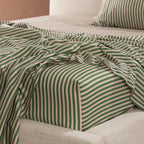Close-up of the Marlo Mia Stripe fitted sheet highlighting the green and blush stripe design and smooth cotton sateen finish.