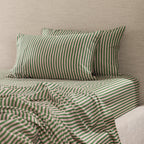 Marlo Mia Stripe fitted sheet styled on a bed with matching striped pillowcases, showcasing the coordinated stripe pattern.
