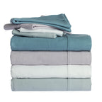 A stack of four folded flannelette bed sheets photographed on a clean white background.