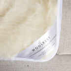 Woolrest 600gsm reversible New Zealand wool underlay close-up showing soft wool pile and fitted corner detail on a mattress.