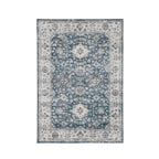 Design Republique Vali Border Chenille Rug (120 × 180cm) in Blue, featuring a distressed vintage-inspired floral medallion design in soft blue, ivory, and grey tones with an ornate decorative border.